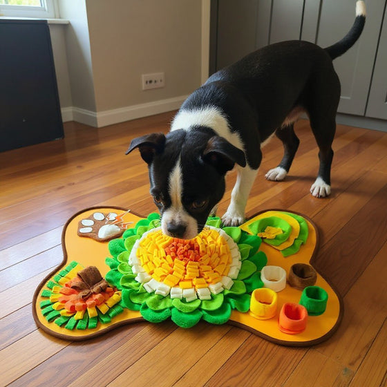 Tom's rescue Staffordshire Bull Terrier nose-down on the Snufflo XL Snuffle Mat in a wooden-floored kitchen.
